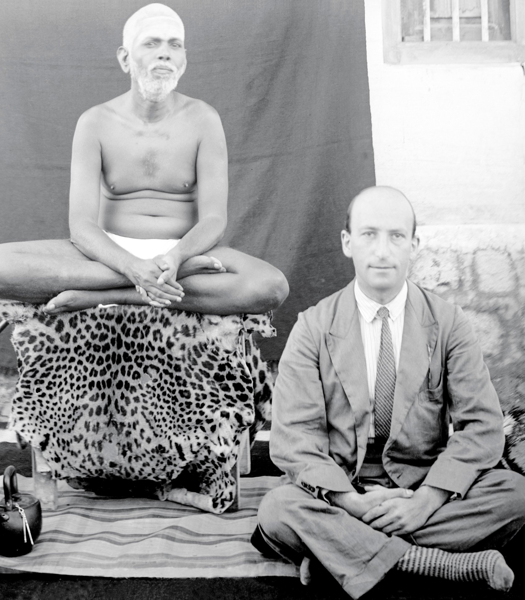 At a sage’s feet: (left to right) Paul Brunton with Ramana Maharshi, likely in the 1930s; cover of A Search in Secret India; Paul Brunton in his later years; his typewriter; also with Ramana Maharshi, ; (below) cover of the Romanian edition of The Hidden Teaching Beyond Yoga